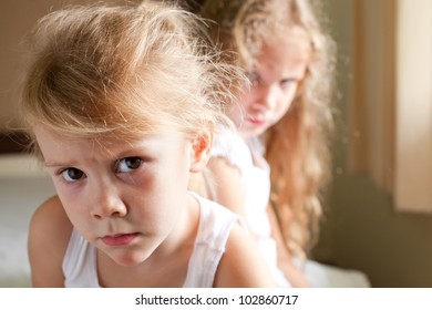 Two Sad Girls On The Bed