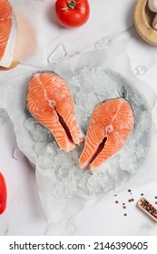 Two Salmon Steaks On Ice With Spices And Tomatoes Around Top View. Advertisement Flat Lay For Seafood Market Or Restaurant. Cook Book Or Recipes Food Photo 