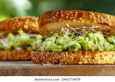 Two sandwich with avocado, eggs and fresh microgreens on a wooden table - Powered by Shutterstock