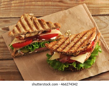 Two Sandwich Pickles On A Paper Towel On Wooden Background In Rustic Style. The View From The Top