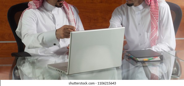 Two Saudi Businessmen Meeting, Working On A Laptop