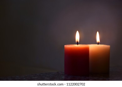 Two Of Scented Candles In The Dark.