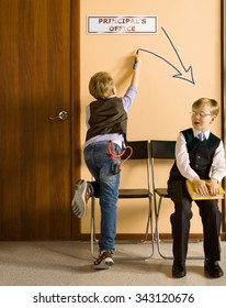 Two Schoolboys Sitting Next To Principal's Office. They Have Different Each Other Behavior And Clothes. One Model Release, Because For Creating This Picture Were Used Two Image Of One And Same Boy.