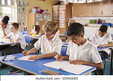 Two Schoolboys Working In A Primary School Class