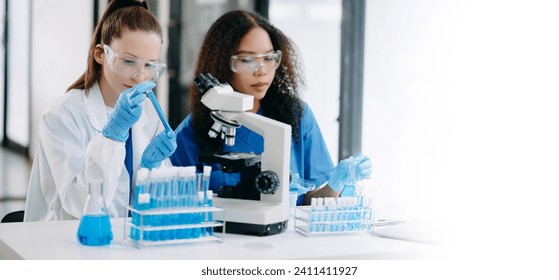 Two scientist or medical technician working, having a medical discuss meeting with an Asian senior female scientist supervisor in the laboratory with online reading, test samples and innovation 
 - Powered by Shutterstock