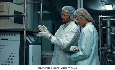 Two Scientist In Professional Uniform Working In Laboratory For Chemical And Biomedical Experiment