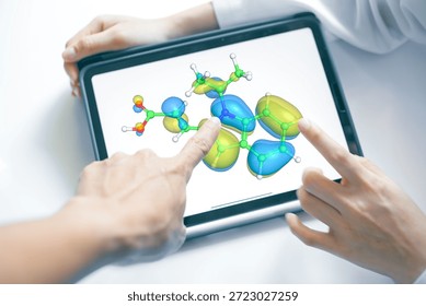Two scientists' hands are pointing at a 3D chemical molecular model on a tablet screen, discussing structural design for pharmaceutical drug development. - Powered by Shutterstock - Get 15% off with code: PIKWIZARD15