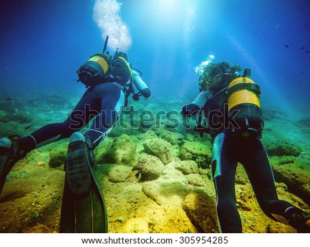 Similar – Two persons in their back with scuba diving equipment exploring the ocean floor.