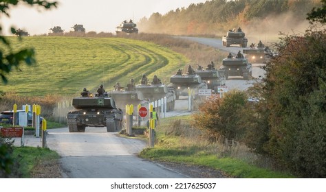 Two Sections Of British Army FV4034 Challenger 2 Ii Main Battle Tanks At A Main Road Junction Crossing, Wiltshire UK