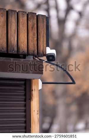 A close‑up of two security cameras mounted on a building corner