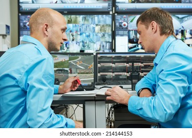 two security guards watching video monitoring surveillance security system