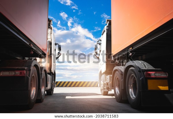 Two Semi\
Trucks a Parking with a Blue Sky. Industry Cargo Freight Truck.\
Logistics and Cargo Transport\
Concept.