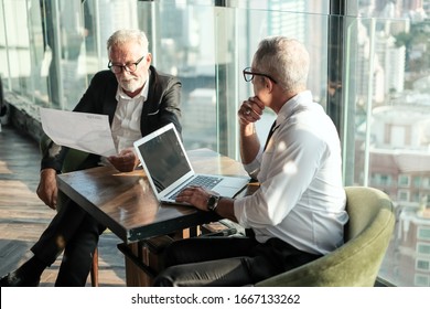 Two Senior Businessman Couple Meeting In Co Working Space At Skyscraper Lounge Or Office