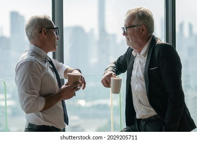 two senior businessman take a break drinking coffee and discussing business strategy in coffee shop at modern restaurant on a tall building cityscape background . old friend talking or life advice  - Powered by Shutterstock