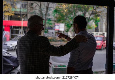 Two Senior Businessmen Are Acknowledging Each Other While Talking, Silhouette