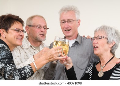 Two Senior Couples Toasting On A Happy New Year.