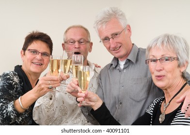 Two Senior Couples Toasting On A Happy New Year.