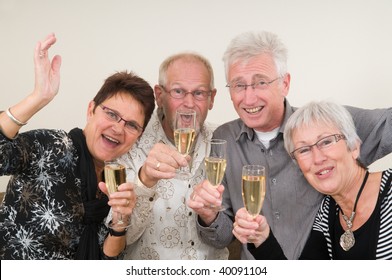 Two Senior Couples Toasting On A Happy New Year.