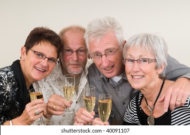 Two Senior Couples Toasting On A Happy New Year.