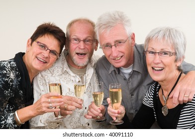 Two Senior Couples Toasting On A Happy New Year.