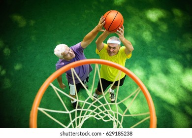 Two Senior Friends Playing Basketball