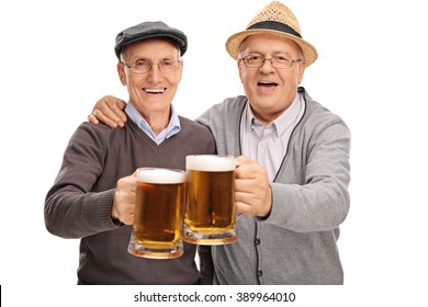Two senior gentlemen making a toast with beer and looking at the camera isolated on white background