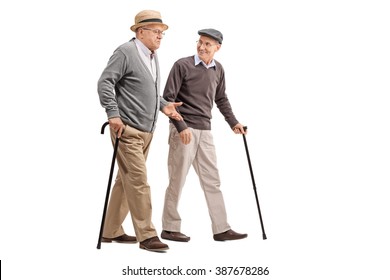 Two Senior Gentlemen Walking And Talking To Each Other Isolated On White Background