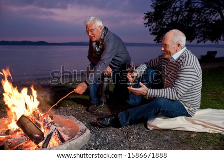 Man Stoking Fire in a Smoker