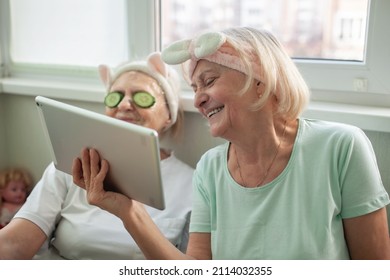 Two Senior Women Apply Facial Cosmetic Mask, Have Fun At Home, Make Selfie And Chat With Friends In Social Media, Wellness And Beauty In Any Age, Body Positivity, Self-esteem And Ageism, Lifestyle