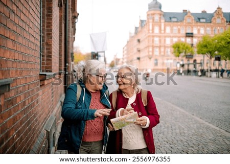 Similar – Image, Stock Photo two sisters laugh heartily on the street