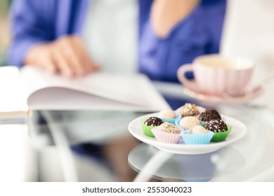 Two senior women relax at a cozy cafe, savoring delicious sweets and engaging in conversation while enjoying their retirement. A warm beverage adds to the inviting atmosphere. - Powered by Shutterstock