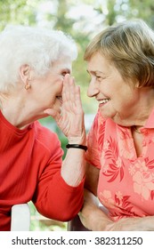 Two Senior Women Sharing A Secret