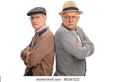 Two seniors angry with each other standing back to back isolated on white background