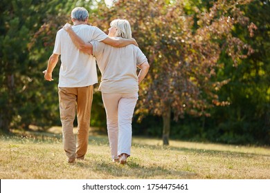 Two Seniors Go For A Walk In Nature In Summer