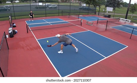 Two Seniors Play A Game Of Pickleball