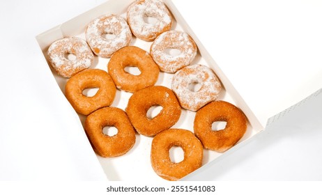 two separate boxes filled with a variety of donuts. The box on the left contains colorful, iced donuts with sprinkles and glaze