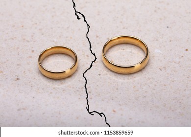 Two Separated Wedding Rings On Cracked Surface - Shutterstock ID 1153859659