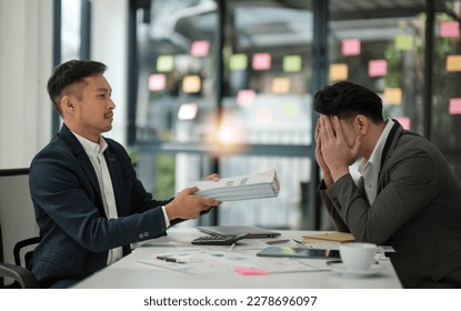 Two serious businessmen discussing project sitting at office desk, using pc laptop, looking at screen, make presentation, create business plan, fulfill task, consider investment - Shutterstock ID 2278696097