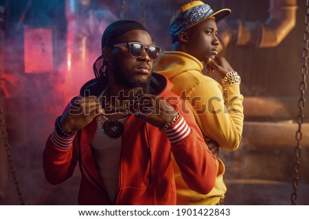 Two serious rappers, breakdancing in studio