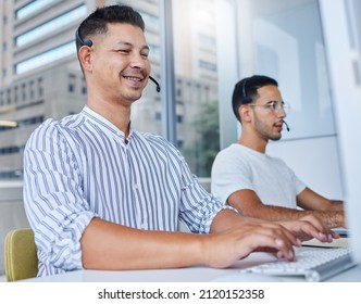 Two Sets Of Brains Are Better Than One. Shot Of Two Business Colleagues Working Together At Their Desks In Their Office.