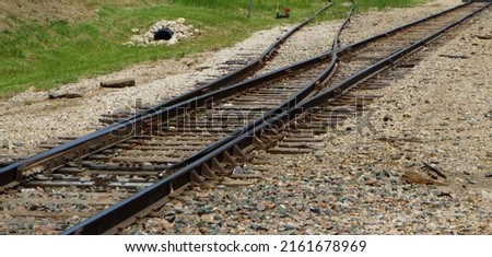 Two sets of rail road tracks coming together or approaching a fork.