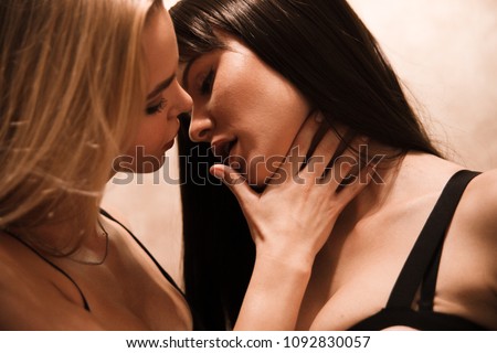 Two sexy girls kissing in the camera