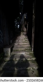 two shadows between the steps in the narrow passage