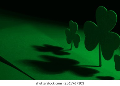 Two shamrocks bathed in green light at an oblique angle - Powered by Shutterstock