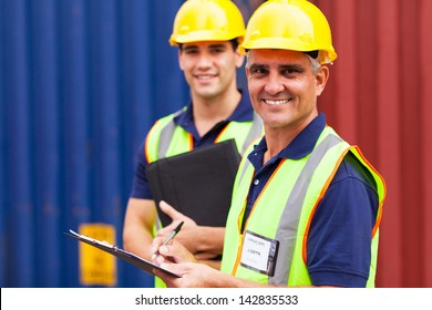 two shipping company workers at container yard - Powered by Shutterstock