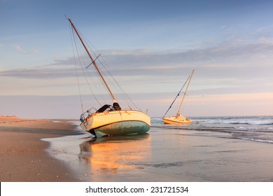Two shipwrecked sailing boats beached on the Cape Hatteras National Seashore on the Outer Banks of North Carolina.