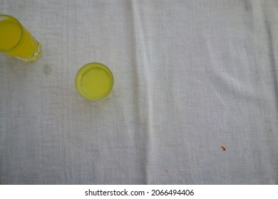 Two Shot Glasses On A White Tablecloth