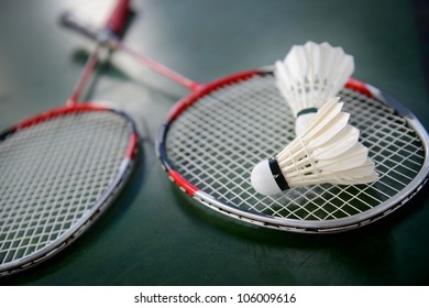two shuttlecocks and badminton racket.
