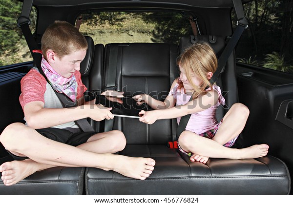 Two Siblings\
Fighting in the Back of a\
Car