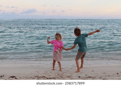 
Two siblings are having fun on the beach.